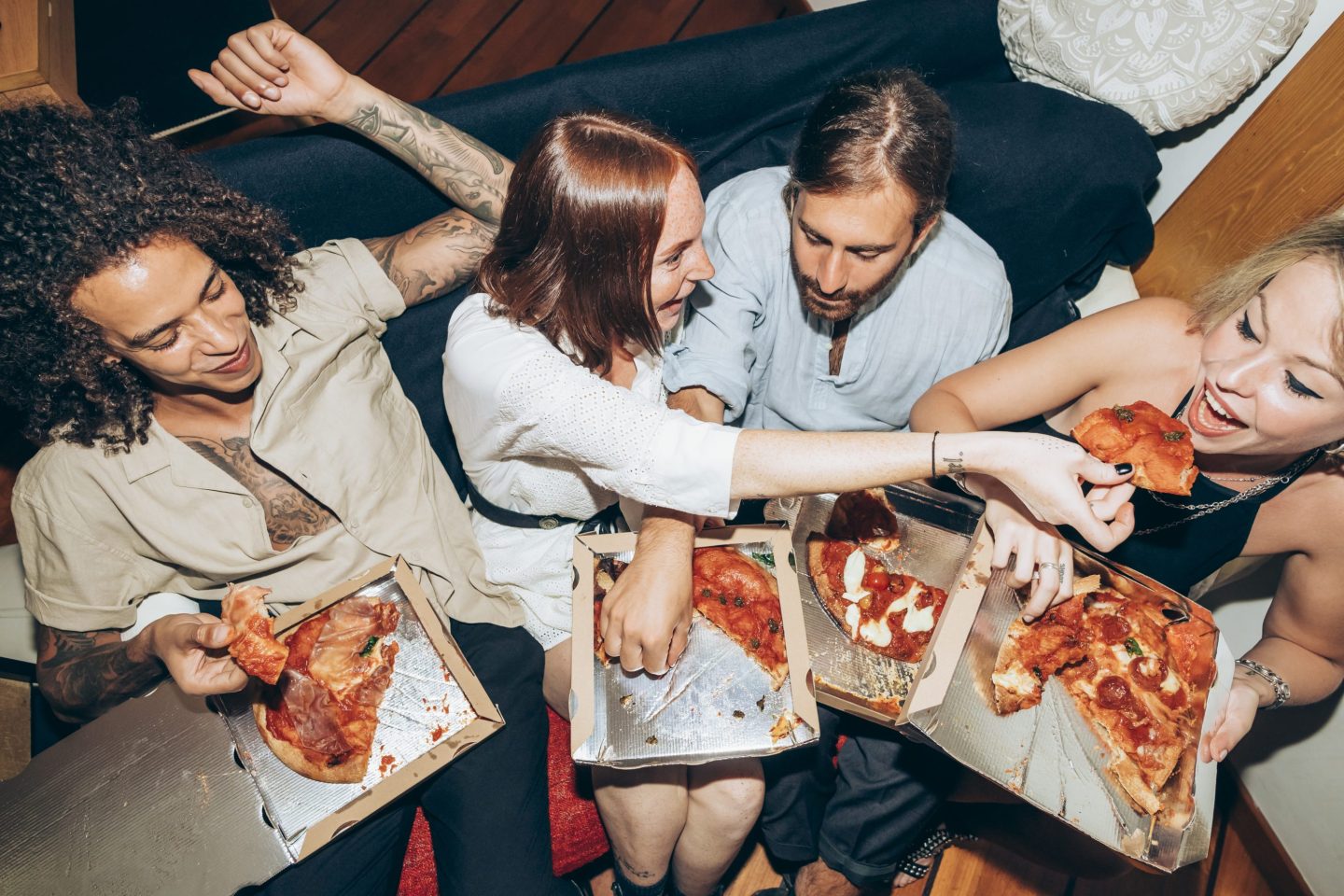 Several people eating pizza