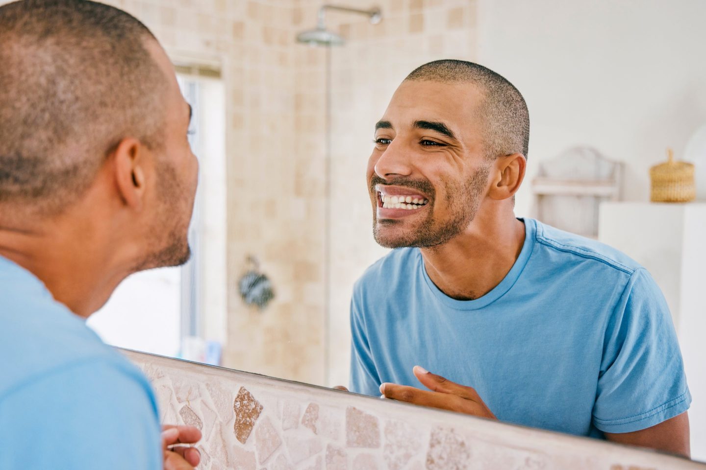 Shot of a young man admiring his freshly brushed teeth in the bathroom mirror at home.