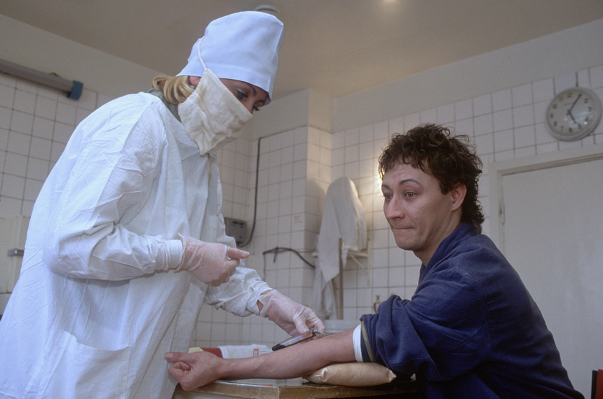 A nurse draws a blood sample from a female AIDS patient in a Moscow hospital. During the political and economic instability of the late 1980s and early 1990s, Soviet agencies downplayed the risks of HIV and AIDS. Foreign literature on HIV and AIDS ceased to be translated in 1991, and information campaigns were dismantled. The public gave little consideration to the threat of HIV during this period which is often associated with Russia's "sexual revolution," an increase in IV drug use, and a surge in prostitution. (Photo by Alain Nogues/Sygma/Sygma via Getty Images)