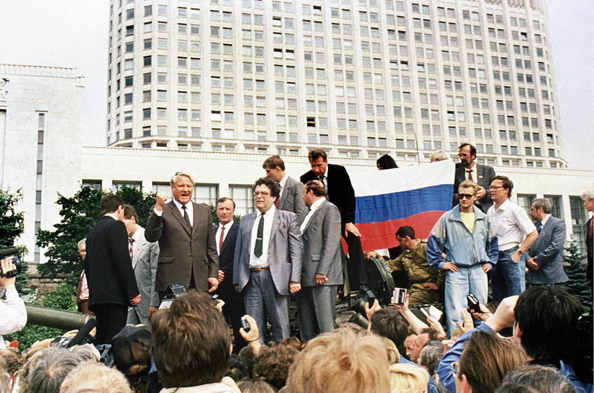 Moscow, RUSSIAN FEDERATION: (FILES) A picture taken 19 August 1991 shows Russian President Boris Yeltsin (L) standing on top of an armoured vehicle parked in front of the Russian Federation building as supporters hold a Russian federation flag in Moscow. Russia's former president Boris Yeltsin died Monday, a Kremlin spokesman told AFP Monday. He was 76. "Former president Boris Yeltsin died today," the spokesman said. AFP PHOTO FILES  (Photo credit should read DIANE-LU HOVASSE/AFP/Getty Images)