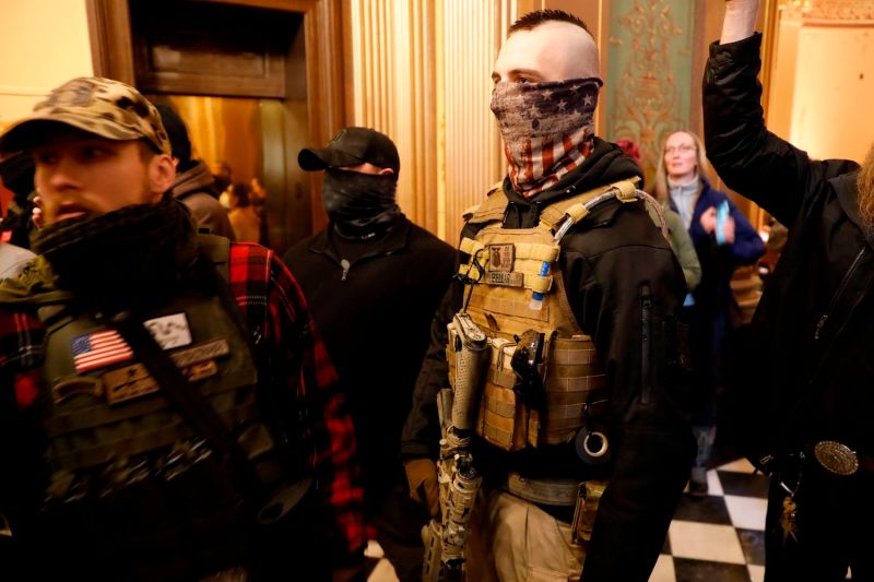Protesters try to enter the Michigan House of Representatives chamber and are kept out by State Police at the Michigan State Capitol in Lansing, Michigan on April 30.