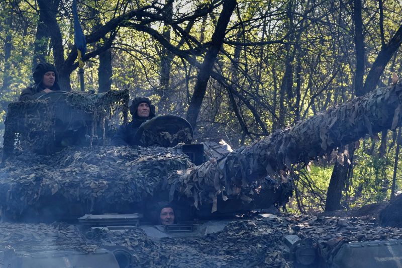Ukrainian service members of the Adam tactical group ride a T-64 tank toward a front line near the town of Bakhmut, Donetsk region.