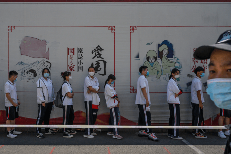 Chinese students queue to take the National College Entrance Examination at a high school in Beijing.