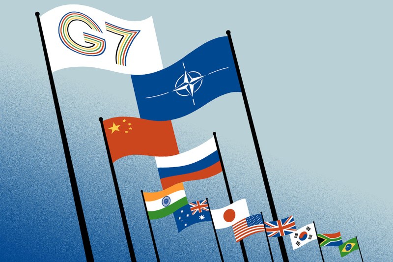 A collection of illustrated flags fly over a textured background that fades from blue to gray. The flags of the G-7 and NATO are the largest and positioned near the top of the image. Beneath them are the smaller flags of individual countries, including China, Russia, India, and others.