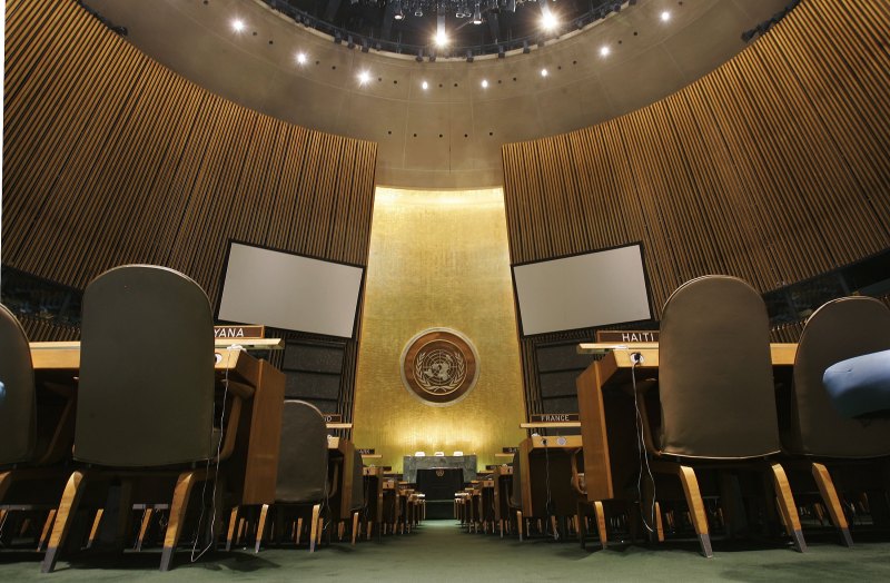 The United Nations logo is seen on the back wall of the General Assembly Hall at U.N. headquarters in New York on May 12, 2006.