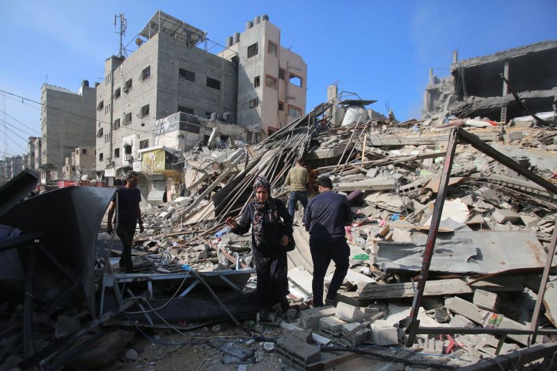 Palestinians inspect damage in Gaza City's Shati refugee camp on Nov. 6, 2023, amid ongoing battles between Israel and Hamas.