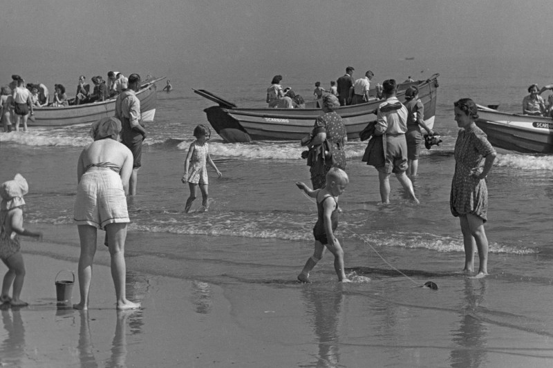 A historic photo of families at the beach.