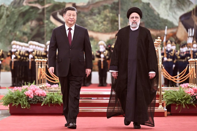 Chinese President Xi Jinping walks with Iranian President Ebrahim Raisi prior to their talks at the Great Hall of the People in Beijing.