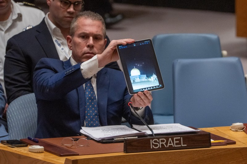 Gilad Erdan, Israel's ambassador to the United Nations, shows a video of Iranian missiles being intercepted over Al-Aqsa Mosque during an emergency meeting of the United Nations Security Council.