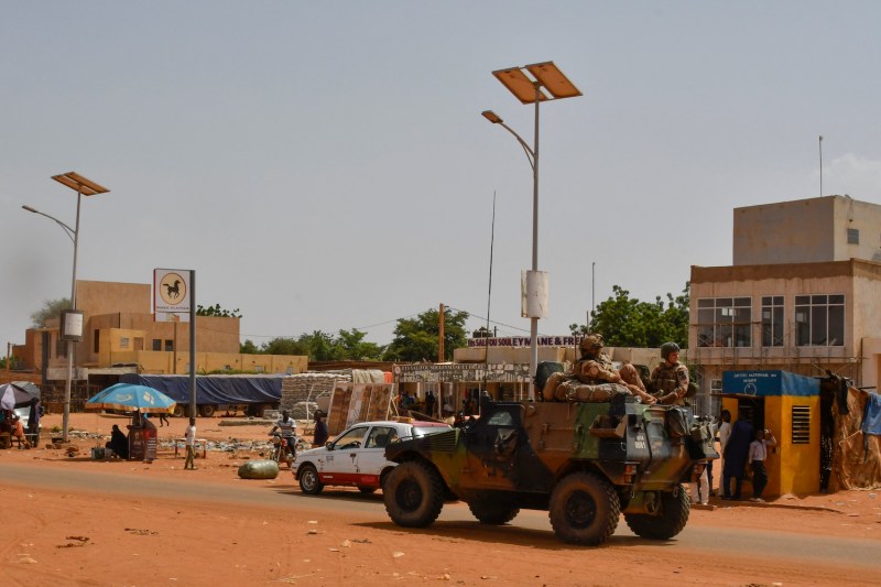 A French Army military vehicle belonging to a convoy of French troops crosses the Lazaret suburb of Niamey.
