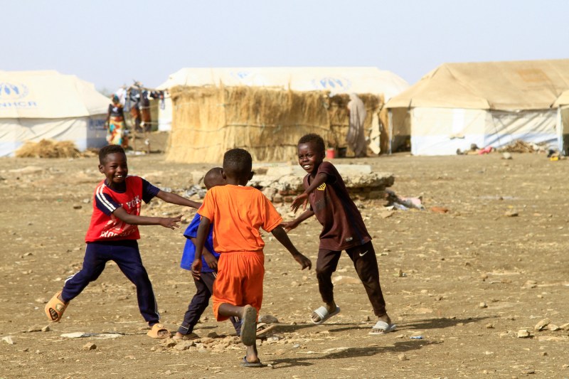 Children play near tents at a camp in southern Gedaref, Sudan.