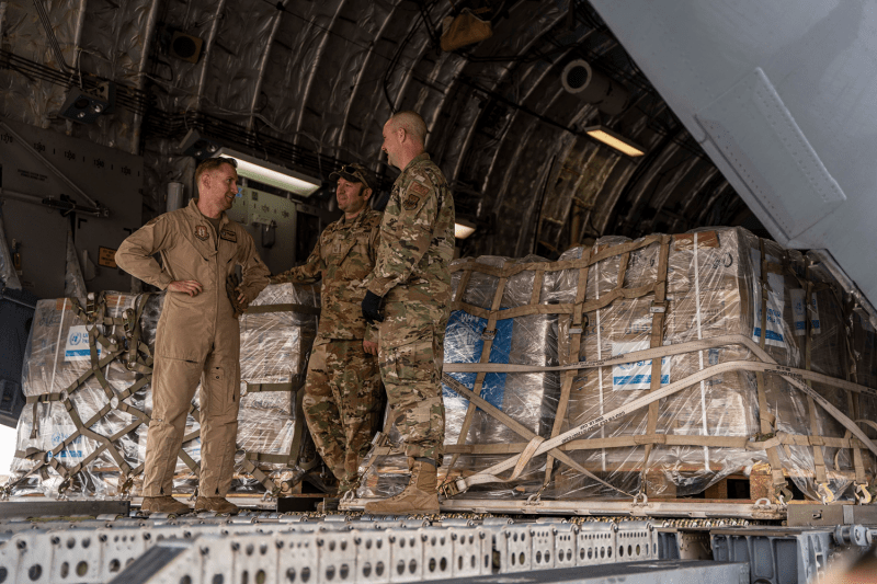 U.S. Air Force personnel stand on a Boeing C-17 Globemaster III as it prepares to deliver aid intended for the Gaza Strip at El Arish International Airport.