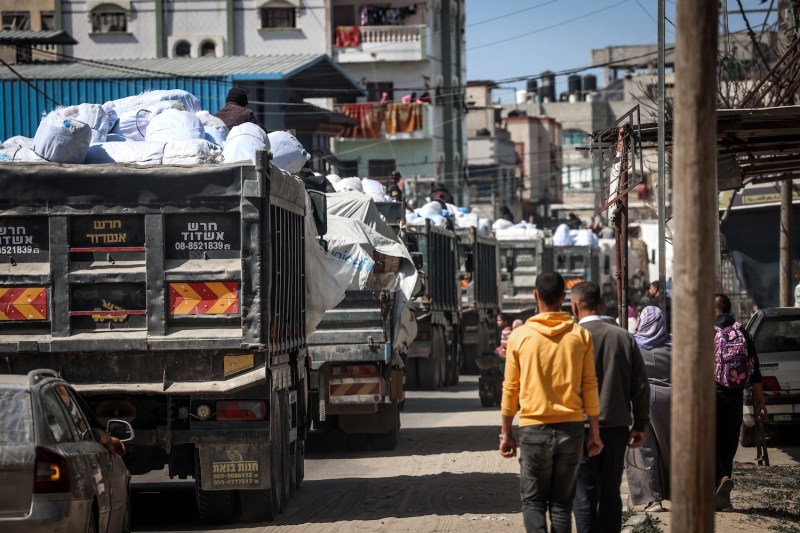 Trucks carrying humanitarian aid make their way along a street in Rafah in the southern Gaza Strip on March 10.
