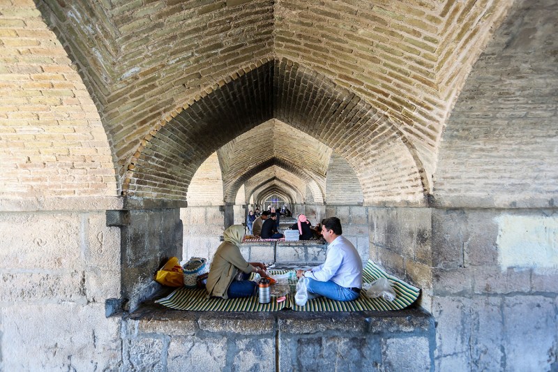 People gather for a picnic under a bridge in Iran's central city of Isfahan, after a reported Israeli strike in the area.