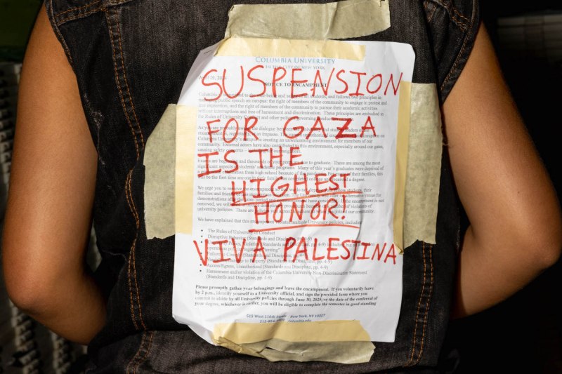 A protester wears the university's disciplinary warning covered over by support for Palestinians in Gaza at Columbia University in New York City.