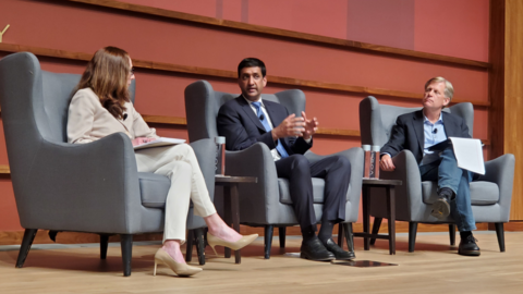 U.S. Congressman Ro Khanna [center] onstage with Amy Zegart [left] and Michael McFaul [right].