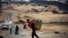 Palestinians carry their belongings as they prepare to flee Rafah in the southern Gaza Strip on May 13, 2024, amid the ongoing conflict between Israel and the Hamas militant group. 