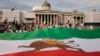FILE - Demonstrators display a pre-revolution Iran flag as they gather in Trafalgar Square, London, Sept. 16, 2023. Iranian dissident groups accused London police on May 30, 2024, of not doing enough to identify and apprehend aggressive pro-Iran supporters during a May 24 event.