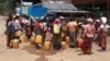 FILE - This photo taken on April 29, 2024, shows Kayah people gathering at a delivery of drinking water by the charity Clean Yangon at a camp for internally displaced people in Demoso township, in Myanmar's eastern Kayah state.