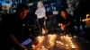 Thai activists hold candles during a vigil for Netiporn Sanesangkhom in Bangkok May 14, 2024. She went on a hunger strike after being jailed for her involvement in protests calling for reform of the country's monarchy system and died Tuesday in a prison hospital, officials said. 
