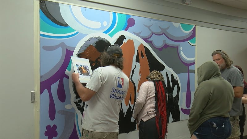 The Shaw Brothers work on a mural with SCORE students.