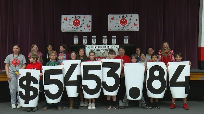 Students from Horace Mann show off their total donation to the Toy Shop of Duncan.