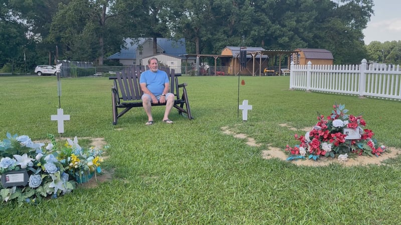Bobby White sits at the graves of his two sons, who died three months apart (2024).