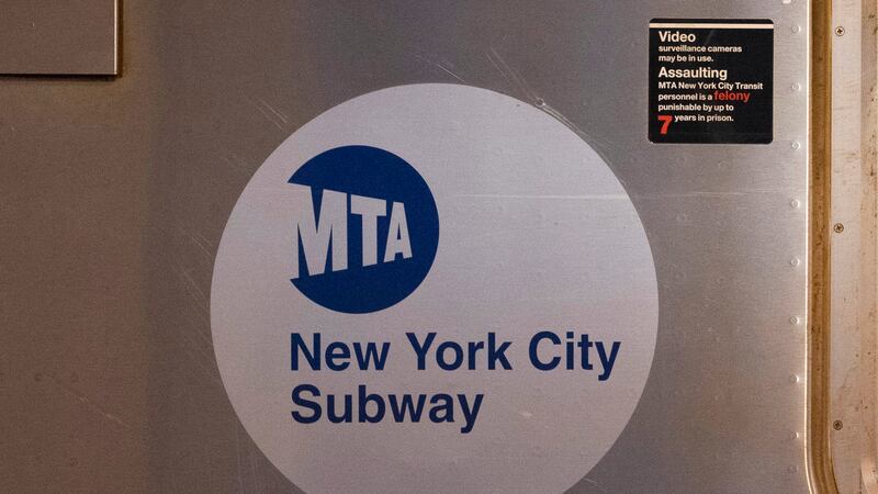 FILE - The MTA logo is seen on the side of a New York City subway car, April 23, 2020, in the...