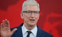 Tim Cook with a raised hand