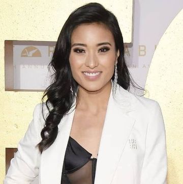 yvonne chapman wearing a white suit and black crop top on the red carpet