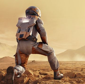 astronaut on mars kneeling looking at space rocket in distance