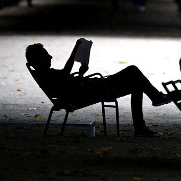 a man reads a book as he rests in jardin du palais royal in paris, on july 9, 2023 photo by sergei gapon afp photo by sergei gaponafp via getty images