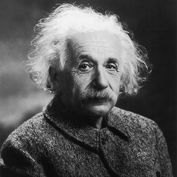 albert einstein looks at the camera with a neutral expression, he is wearing a wool coat
