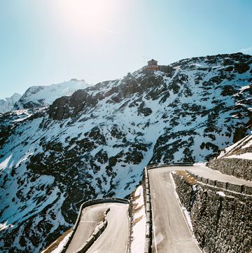 a cyclist descending switchbacks on a mountain road