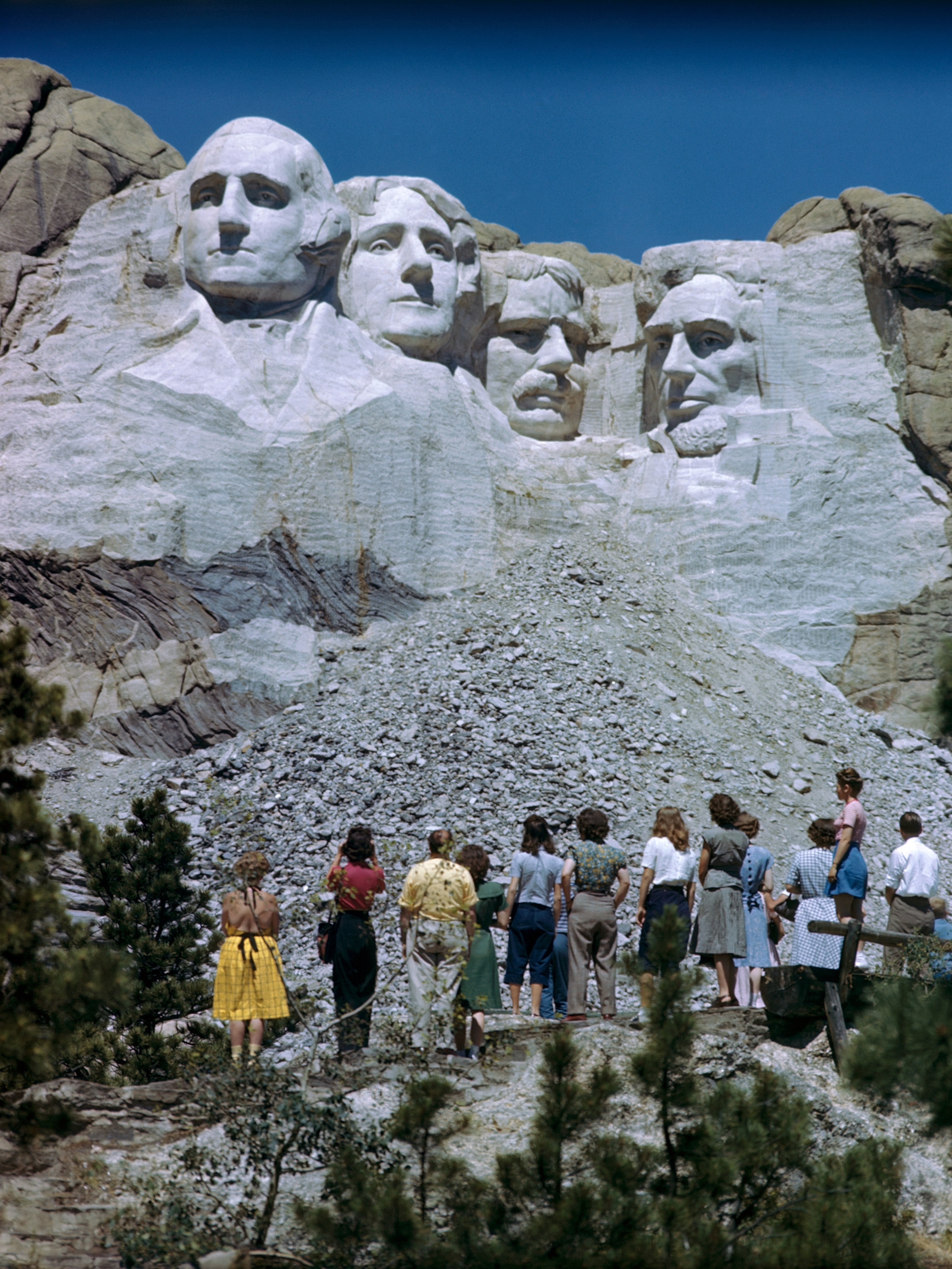 Tourists looking up at Mount Rushmore