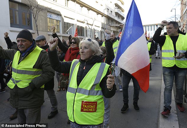 Unionist from the CGT (General Working Confederation) and yellow vest protesters march side by side in Marseille, southern France, Tuesday, Feb. 5, 2019. French public workers are striking in protest against French President Emmanuel Macron's policies and demonstrations are taking place across the country with the CGT labor union calling for a general strike. (AP Photo/Claude Paris)