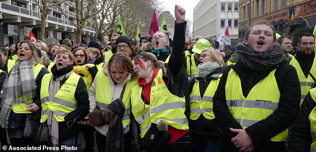 Demonstrators wearing yellow vests take part to a demonstration called by the CGT (General Working Confederation) union, Tuesday, Feb. 5, 2019 in Lille, northern France. Workers, public servants, and retired people were invited to march during a strike called by the CGT (General Working Confederation) union. (AP Photo/Michel Spingler)
