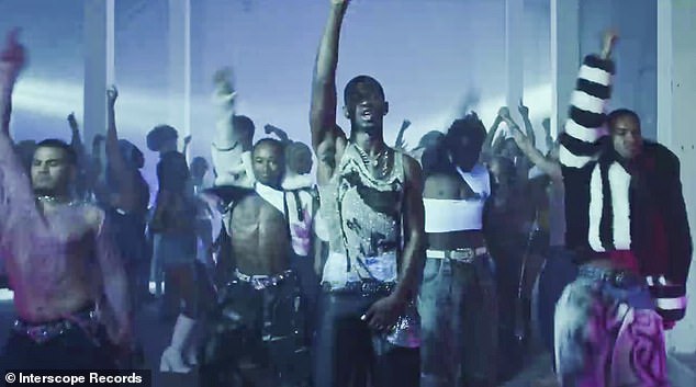 While also singing lyrics, the rapper performed his own choreography in a shimmering, silver and black-patterned tank top and fitted, black pants