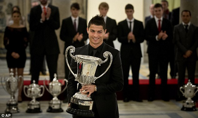 Size does matter: Ronaldo was all smiles as he walked off withe the massive piece of silverware