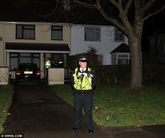 Death: A police officer stands outside the home of Jacintha Saldanha in Bristol this evening