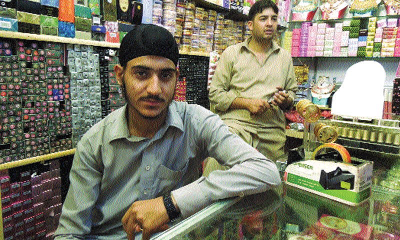 Harpaal Singh sits in his shop. The picture below is of artificial jewellery on display at his shop.