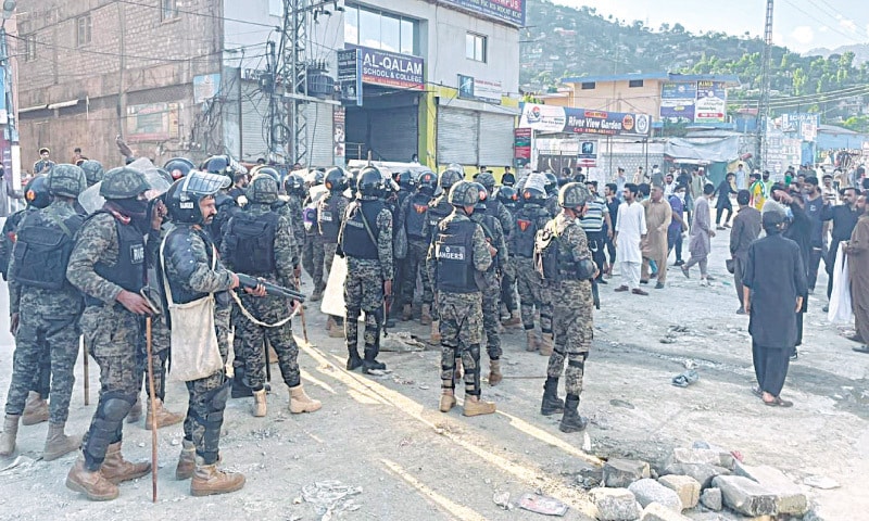 MUZAFFARABAD: Rangers personnel take positions on the Western Bypass shortly before the clashes with protesters, 
on Monday.—Dawn