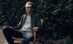 Writer Tom Lamont sitting in a garden, July 2024