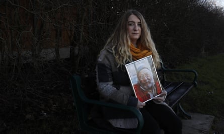 Jo Goodman, co-founder of Covid-19 Bereaved Families for Justice UK group, holds a portrait of her late father, Stuart.