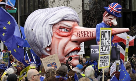 A model head of Theresa May stands among protesters at the People’s Vote march.