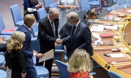 Ghulam Isaczai, left, Afghanistan’s permanent representative to the UN, shakes hands with the secretary general, António Guterres, at the start of a UN security souncil meeting on the situation in Afghanistan.