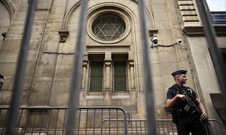 A French riot police officer guards the Grand Synagogue of Paris, two days after security measures were reinforced near Jewish temples and schools.