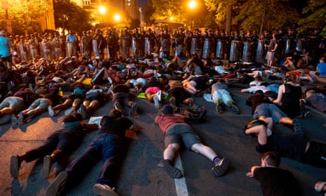 Demonstrators lie on the ground facing a police line in front of the White House during protests over the death of George Floyd in Washington DC on Wednesday.