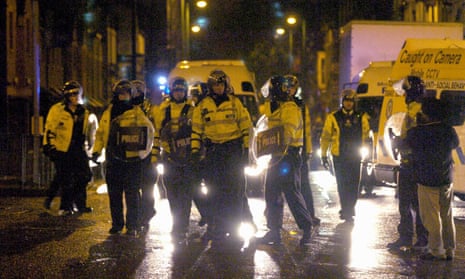 Police in riot gear take to the streets at night in Birmingham in October 2005