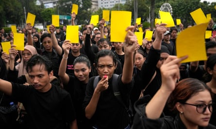 Activists in Jakarta hold yellow cards to symbolise a warning during a weekly protest held by the relatives of the victims of human rights violations.